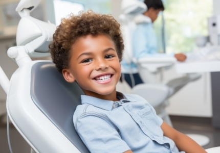 Little boy smiling in dental chair